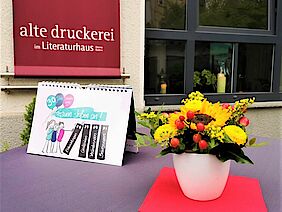 Blumen-geschmückter Stehtisch vor der Alten Druckerei